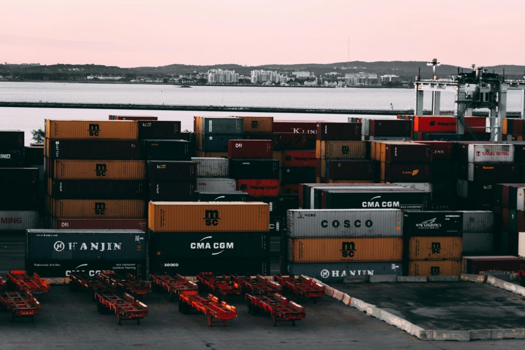 pexels photo 2091159 2091159 A bustling container yard at a seaport with shipping containers stacked and ready for transport at twilight.